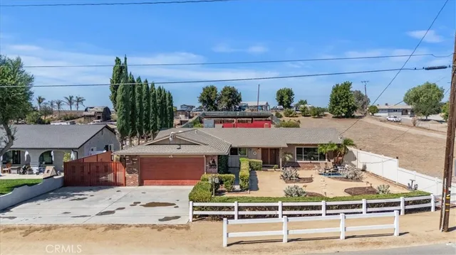 a view of a patio with table and chairs potted plants