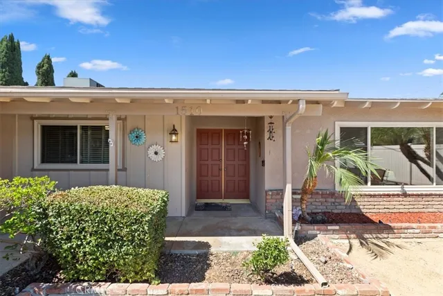 a livingroom with workspace and a couch