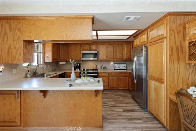 a kitchen with stainless steel appliances granite countertop a refrigerator and a sink