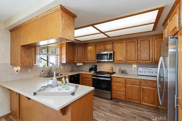 a view of a workspace with furniture and chandelier fan