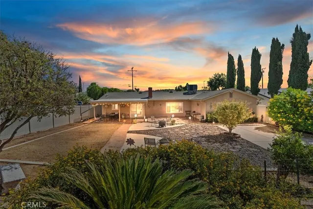a front view of a house with a yard and seating space