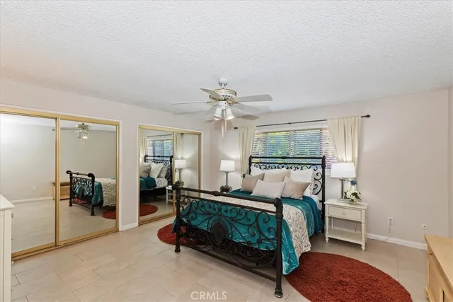 a front view of house with yard outdoor seating and barbeque in the background