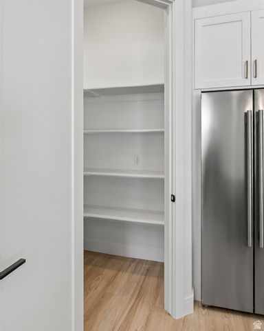 2862 South Mountain Rnch Road Cedar City, UT 84720 - Photo 19 of 64 Walk-in pantry featuring multiple white shelving units and wood-finish flooring