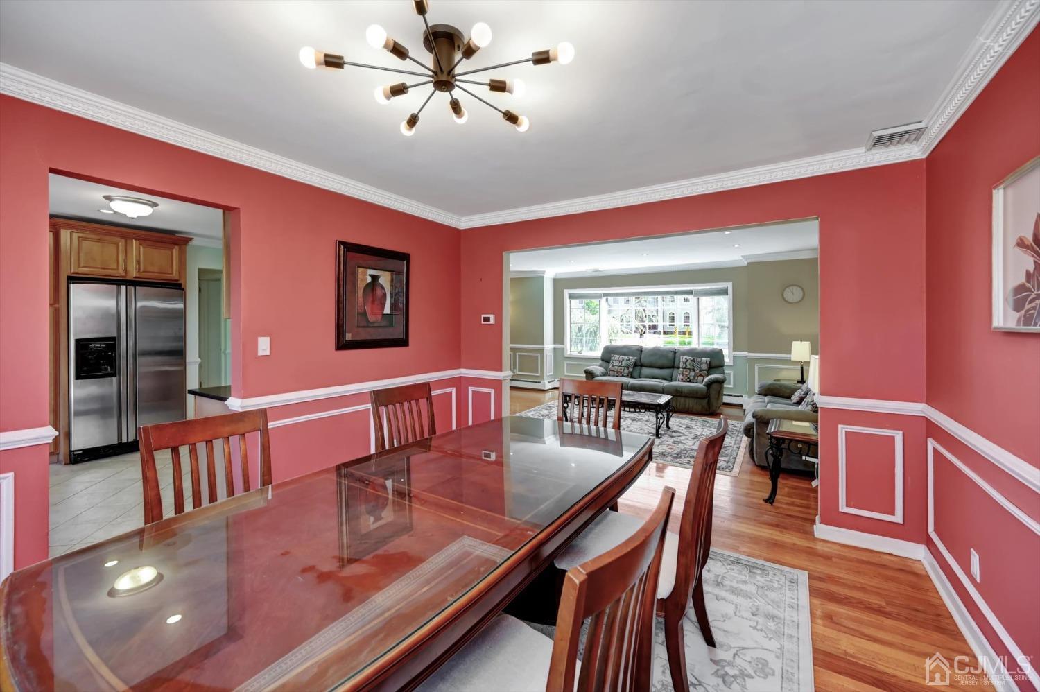 481 Plainfield Road Edison, NJ 08820 - Photo 11 of 42 a dining room with wooden floor and chandelier