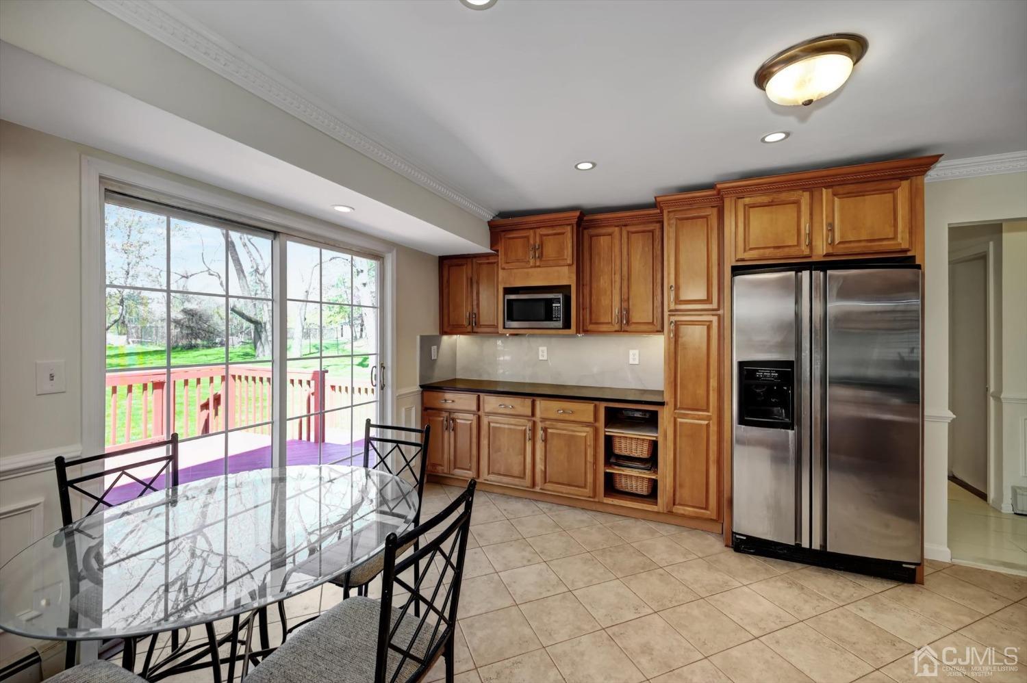 481 Plainfield Road Edison, NJ 08820 - Photo 15 of 42 a kitchen with a refrigerator a stove top oven and kitchen island