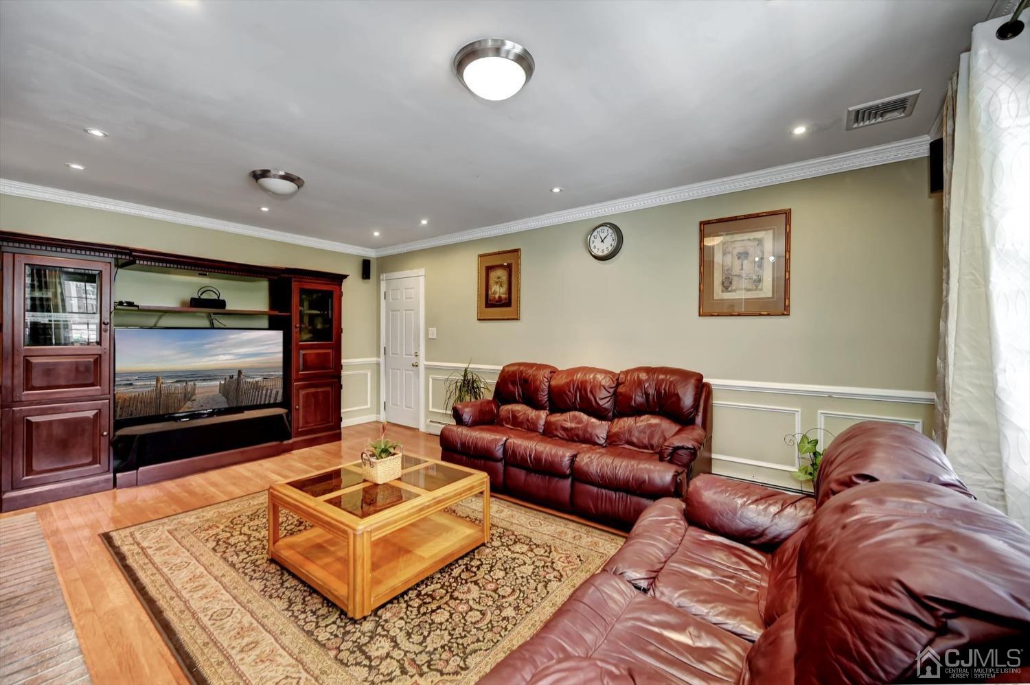 481 Plainfield Road Edison, NJ 08820 - Photo 17 of 42 a living room with furniture and a flat screen tv