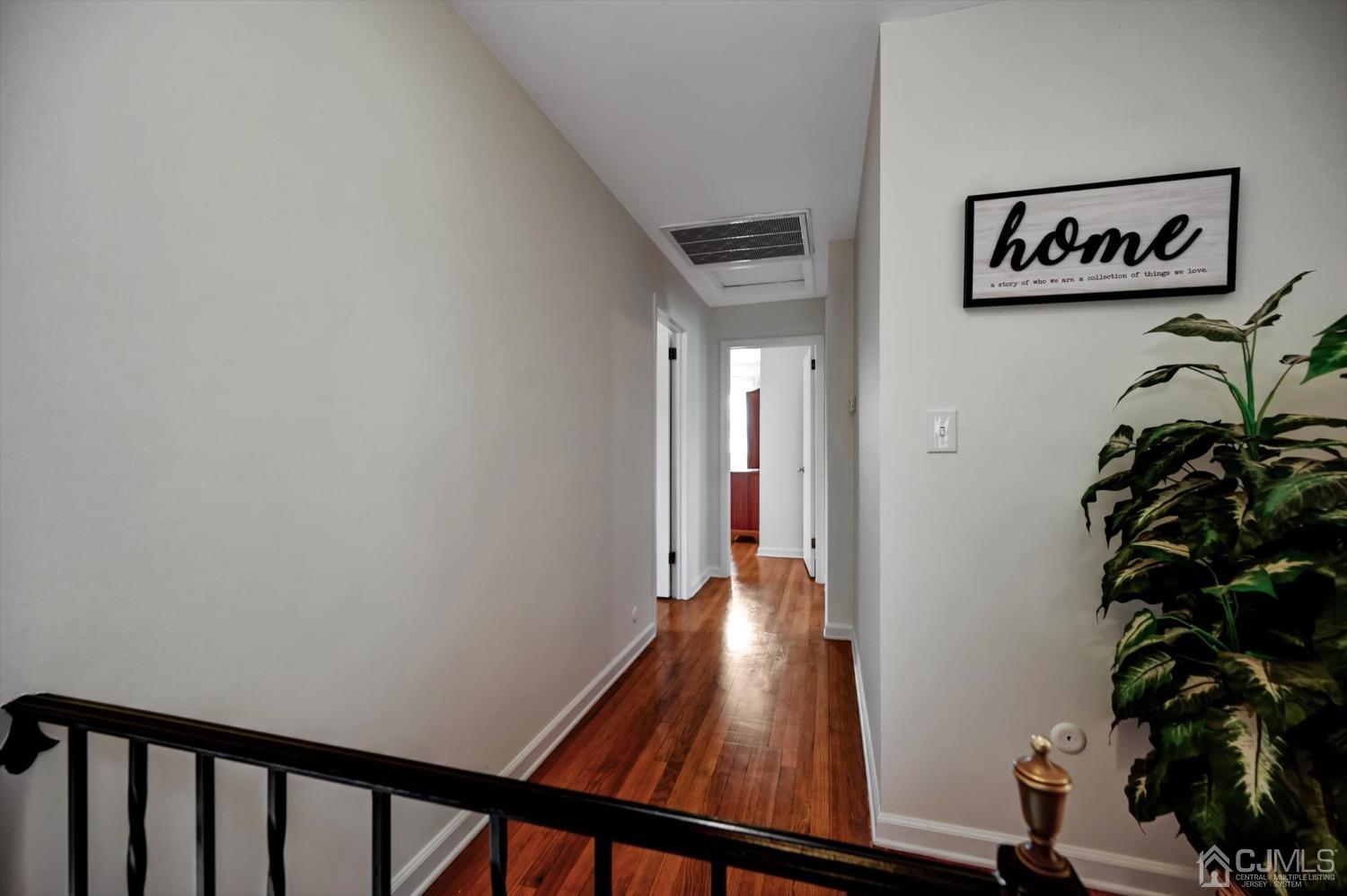 481 Plainfield Road Edison, NJ 08820 - Photo 22 of 42 a view of a hallway with wooden floor and a potted plant