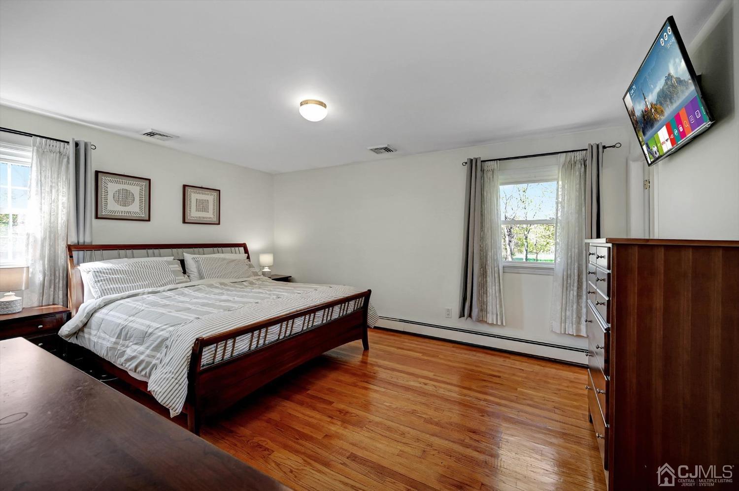 481 Plainfield Road Edison, NJ 08820 - Photo 23 of 42 a bedroom with a large bed and a flat screen tv