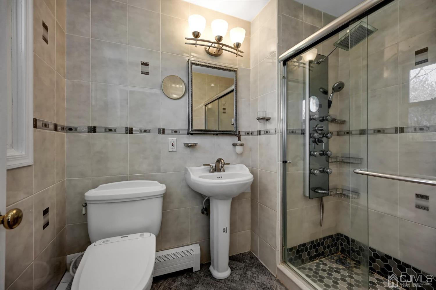 481 Plainfield Road Edison, NJ 08820 - Photo 26 of 42 a bathroom with a sink a toilet and shower