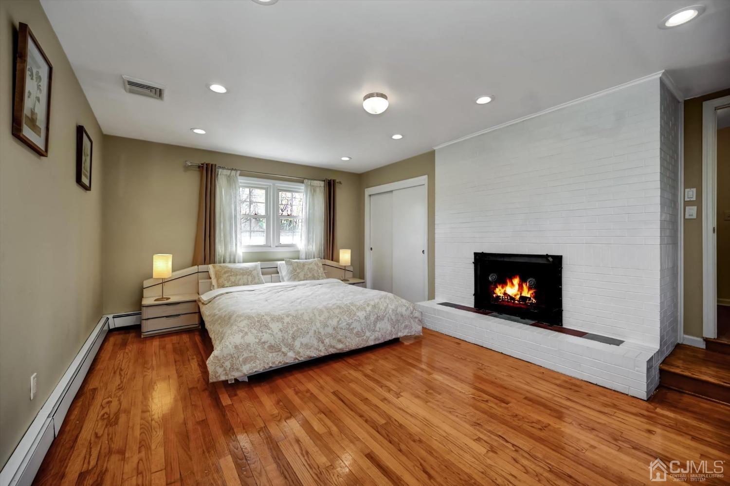 481 Plainfield Road Edison, NJ 08820 - Photo 27 of 42 a spacious bedroom with a bed and a fireplace