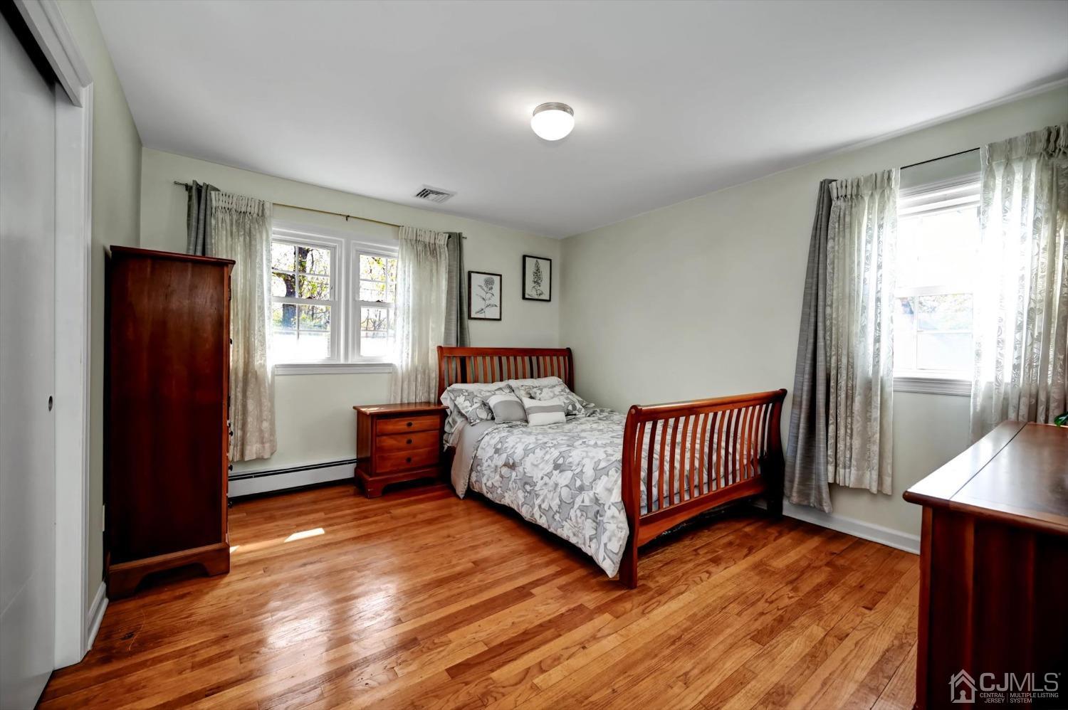 481 Plainfield Road Edison, NJ 08820 - Photo 29 of 42 a bedroom with a bed and wooden floor