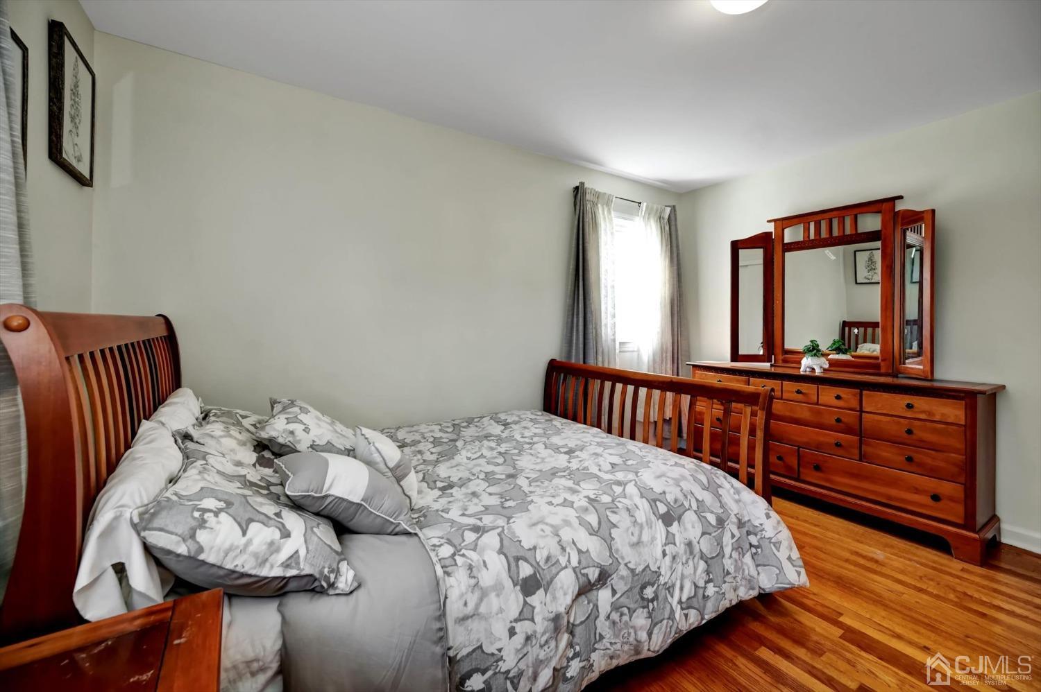 481 Plainfield Road Edison, NJ 08820 - Photo 30 of 42 a bedroom with a bed and a dresser