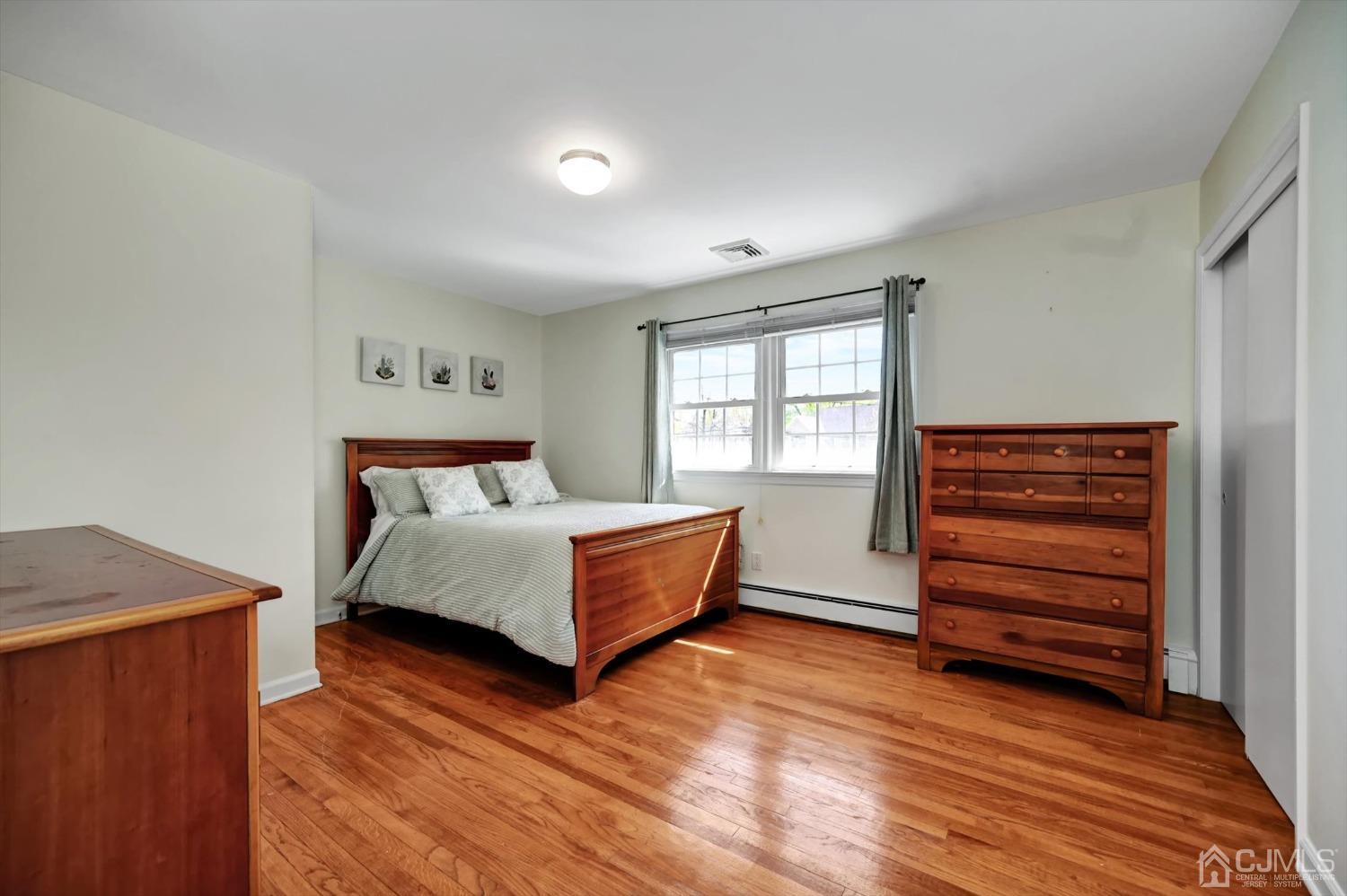 481 Plainfield Road Edison, NJ 08820 - Photo 31 of 42 a bedroom with a bed and a dresser