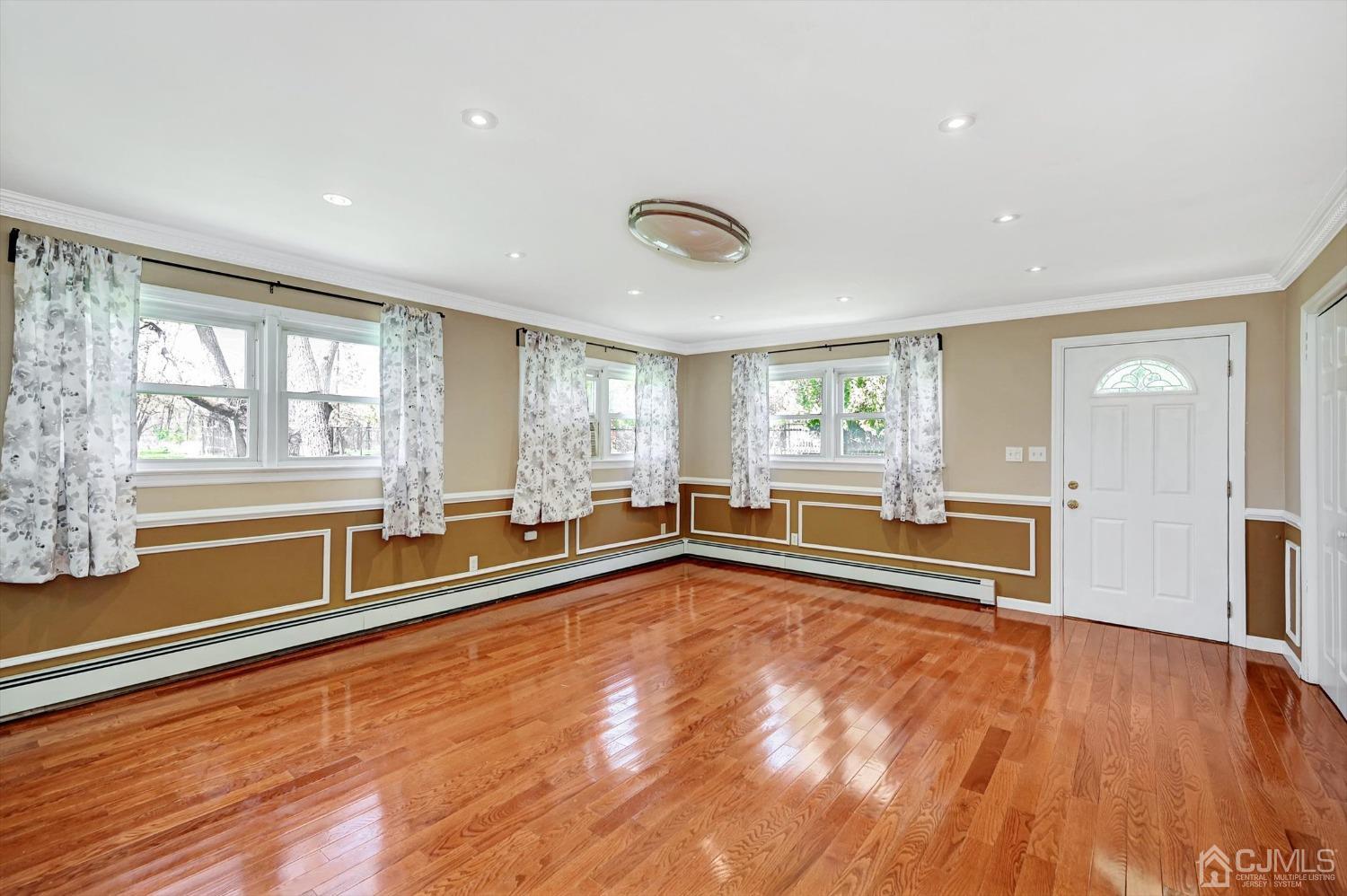 481 Plainfield Road Edison, NJ 08820 - Photo 34 of 42 a view of an empty room with a window and wooden floor