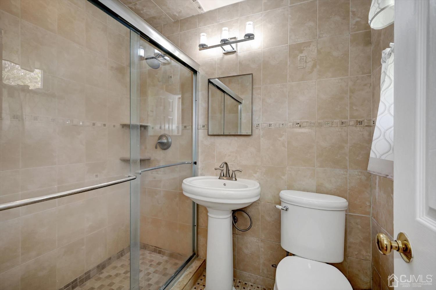 481 Plainfield Road Edison, NJ 08820 - Photo 36 of 42 a bathroom with a sink mirror and toilet