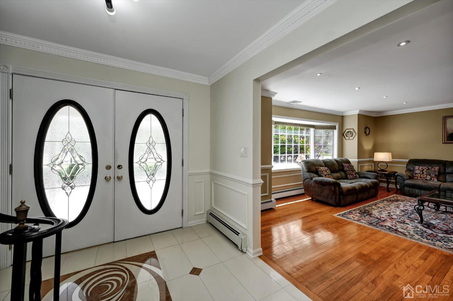 481 Plainfield Road Edison, NJ 08820 - Photo 8 of 42 a living room with furniture a large window and a rug
