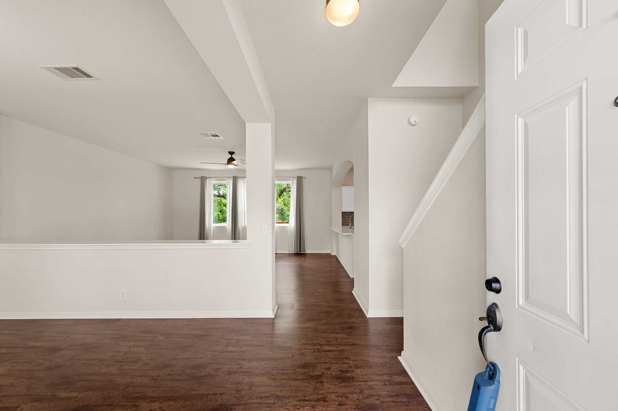 8902 Magna Carta Loop, Unit 122 Austin, TX 78754 - Photo 4 of 39 Rich hardwood floors welcome guests into this inviting open-concept living area.