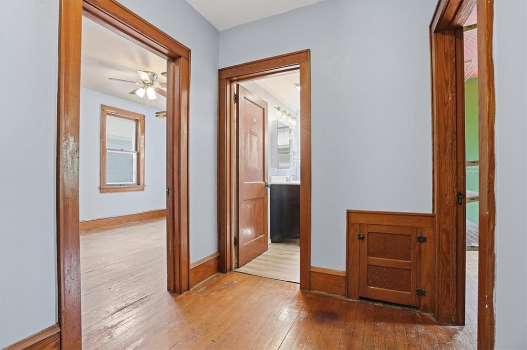 167 Main Road Lehighton, PA 18235 - Photo 21 of 41 Rich hardwood floors lead to a well-lit interior, highlighting classic wooden trim and accessible spaces.