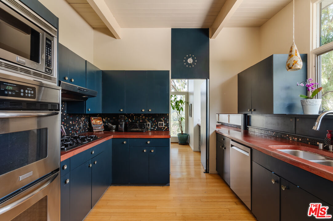 2980 Edgewick Road Glendale, CA 91206 - Photo 13 of 34 a kitchen with stainless steel appliances granite countertop a stove a sink and a microwave