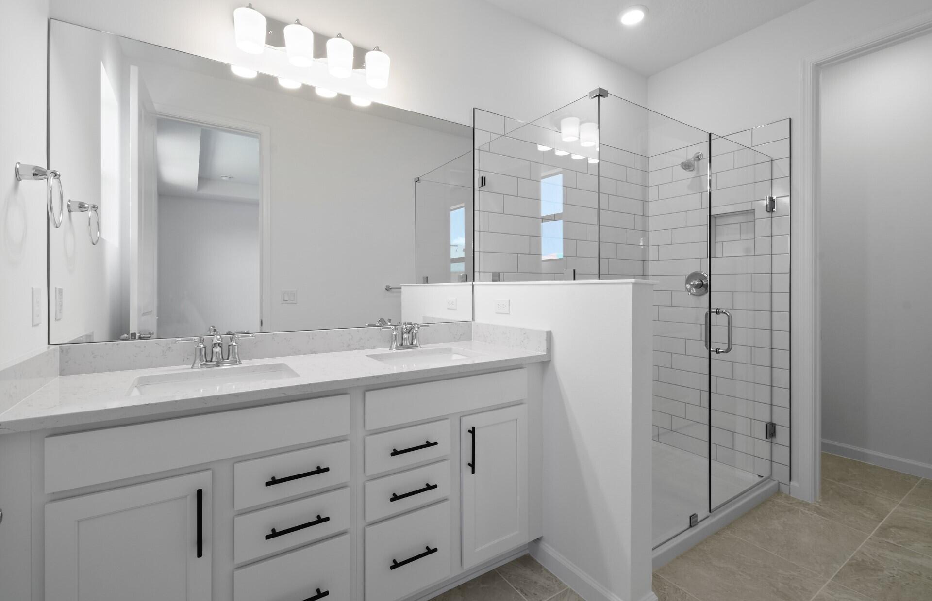 276 Southwest Sally Way, Unit LATITUDE 6613 Stuart, FL 34997 - Photo 9 of 22 a bathroom with double sink and a mirror