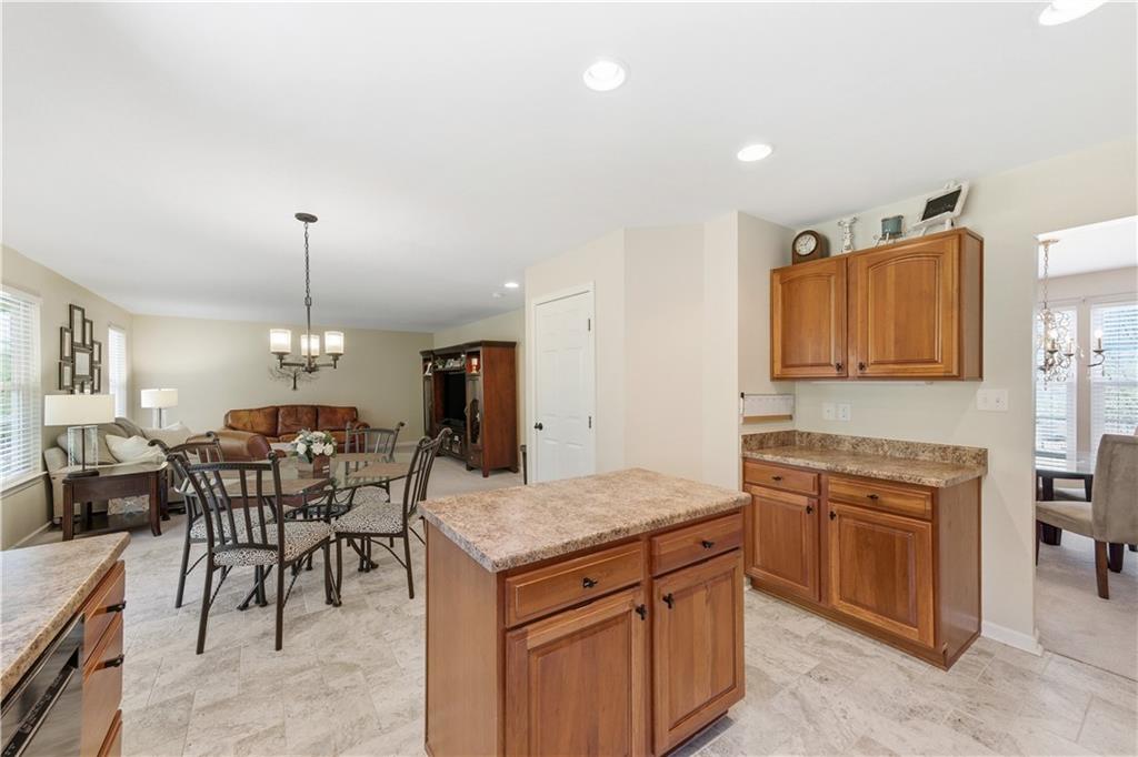 155 Broadstone Drive Mars, PA 16046 - Photo 13 of 30 a kitchen with a stove a sink a dining table and chairs