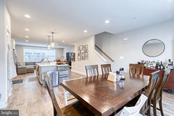 an open kitchen with dining table and chairs