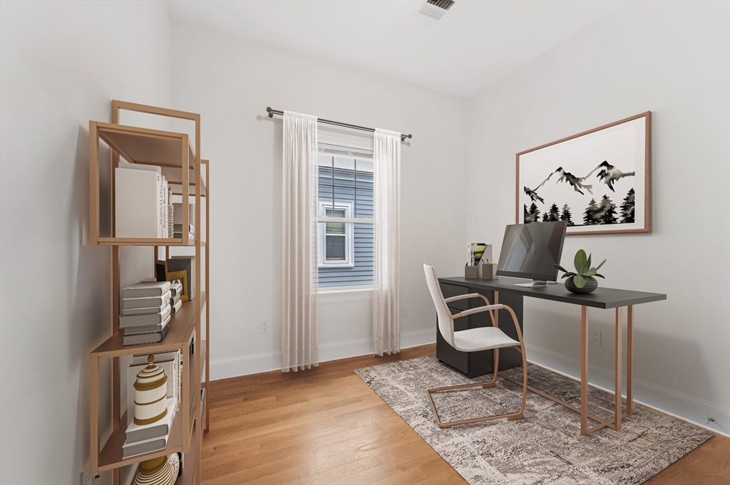 6 Marie Street, Unit 3 Boston, MA 02122 - Photo 14 of 25 a view of a workspace with furniture and wooden floor