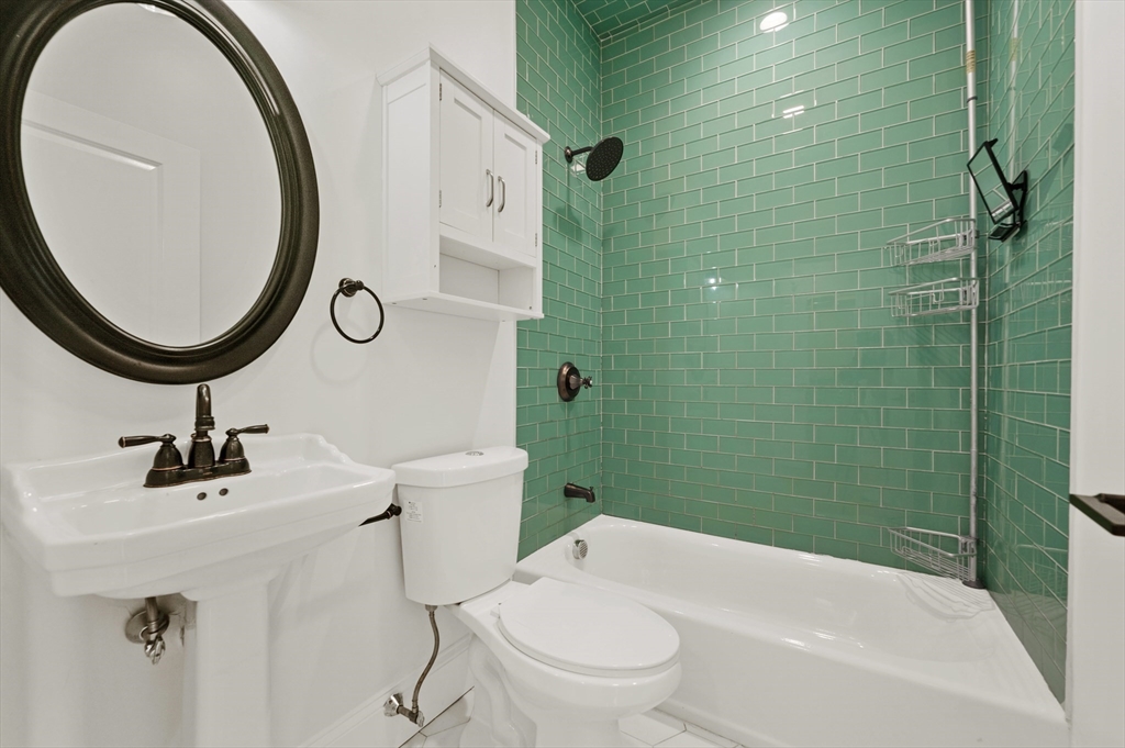 6 Marie Street, Unit 3 Boston, MA 02122 - Photo 19 of 25 a bathroom with a sink a toilet and a mirror