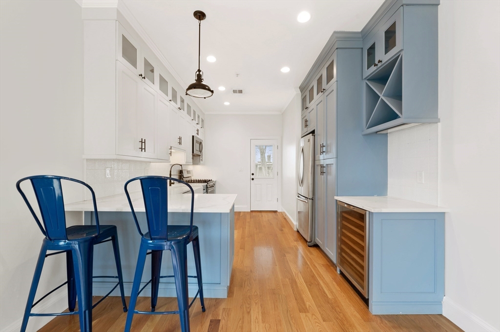 6 Marie Street, Unit 3 Boston, MA 02122 - Photo 2 of 25 a view of a dining room with furniture and wooden floor