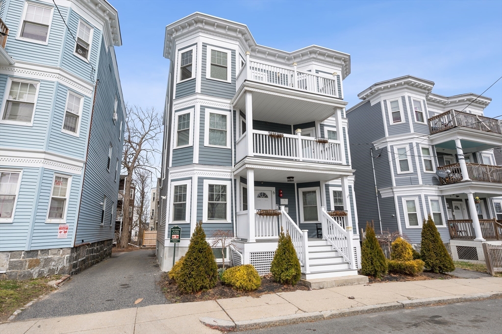 6 Marie Street, Unit 3 Boston, MA 02122 - Photo 24 of 25 a front view of a residential apartment building with a yard