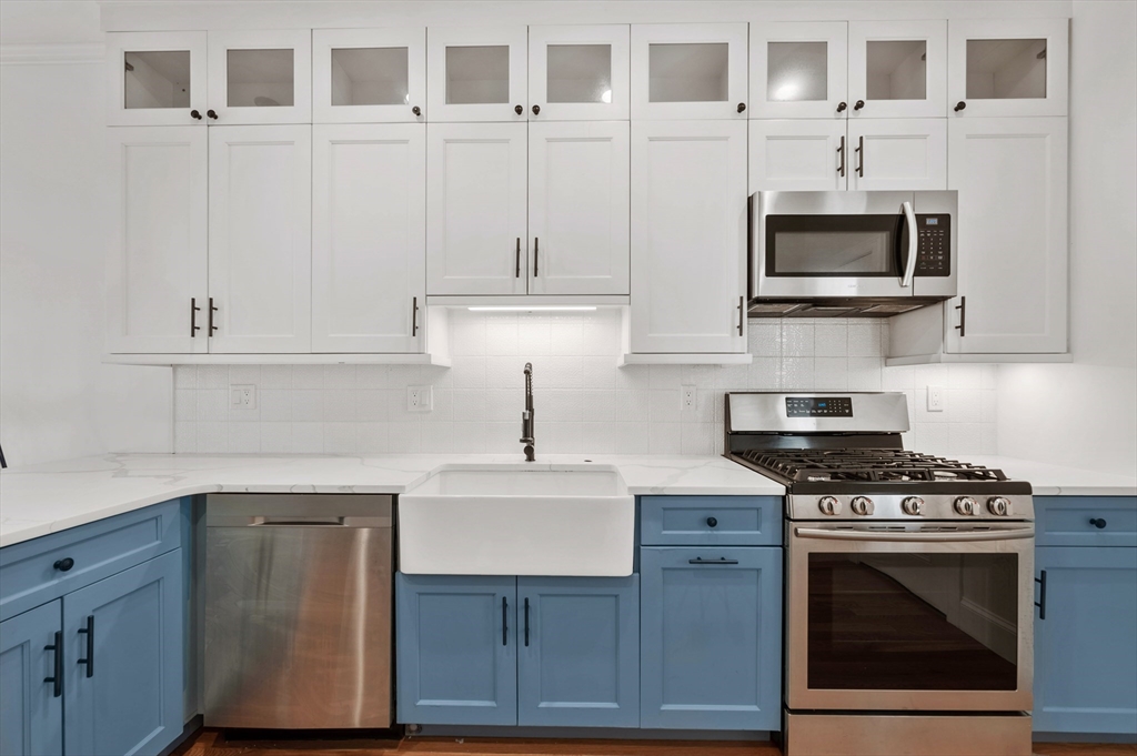 6 Marie Street, Unit 3 Boston, MA 02122 - Photo 5 of 25 a kitchen with cabinets and appliances