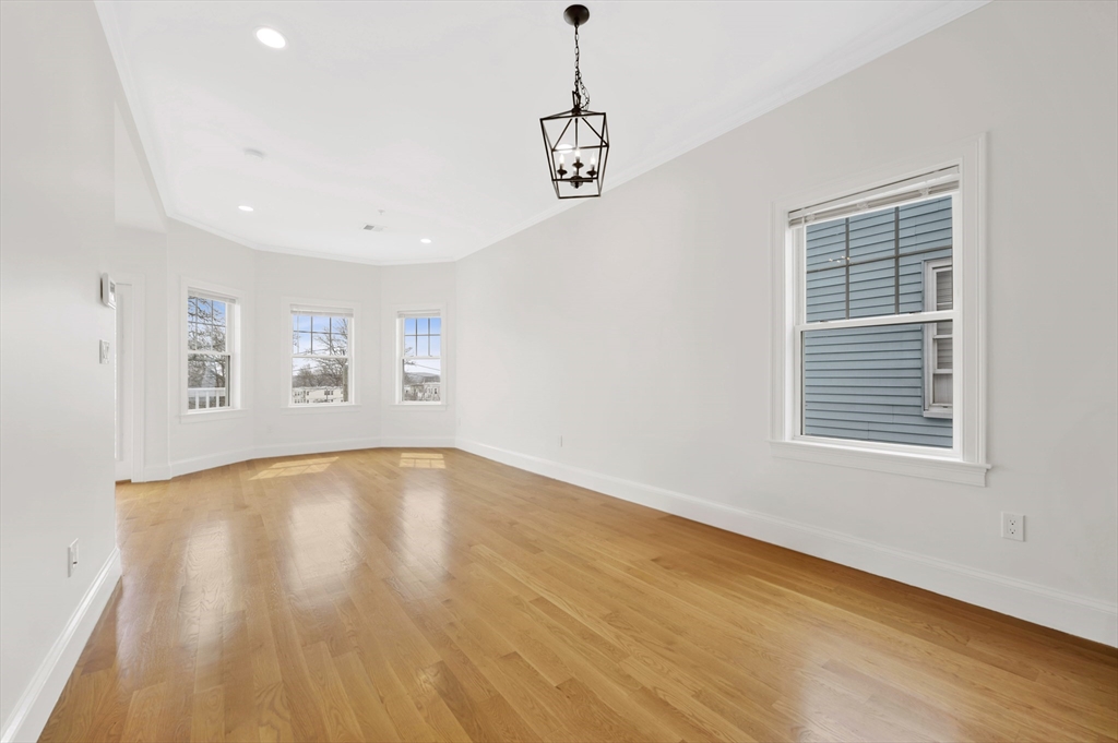 6 Marie Street, Unit 3 Boston, MA 02122 - Photo 8 of 25 a view of an empty room with a window and wooden floor