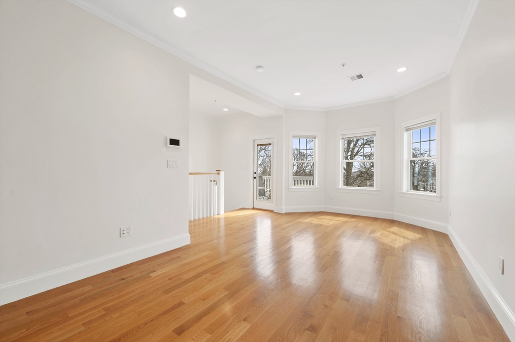 6 Marie Street, Unit 3 Boston, MA 02122 - Photo 9 of 25 a view of empty room with wooden floor and fan