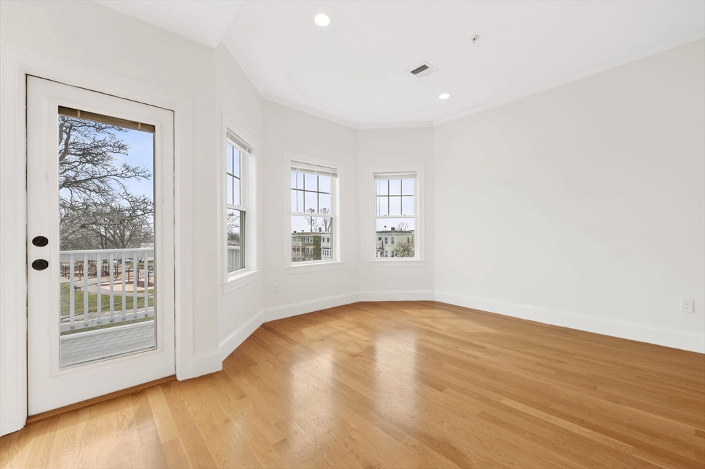 6 Marie Street, Unit 3 Boston, MA 02122 - Photo 10 of 25 an empty room with wooden floor and windows