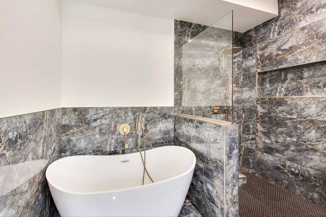 a bathroom with a bathtub and shower