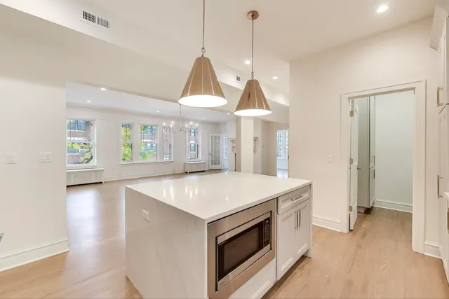 a view of a kitchen and window with wooden floor