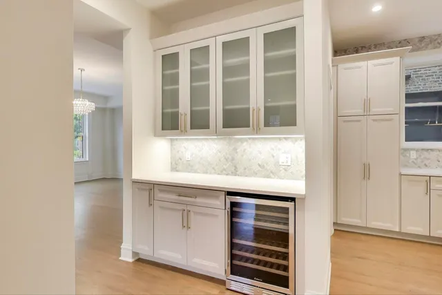 a kitchen with a refrigerator and cabinets