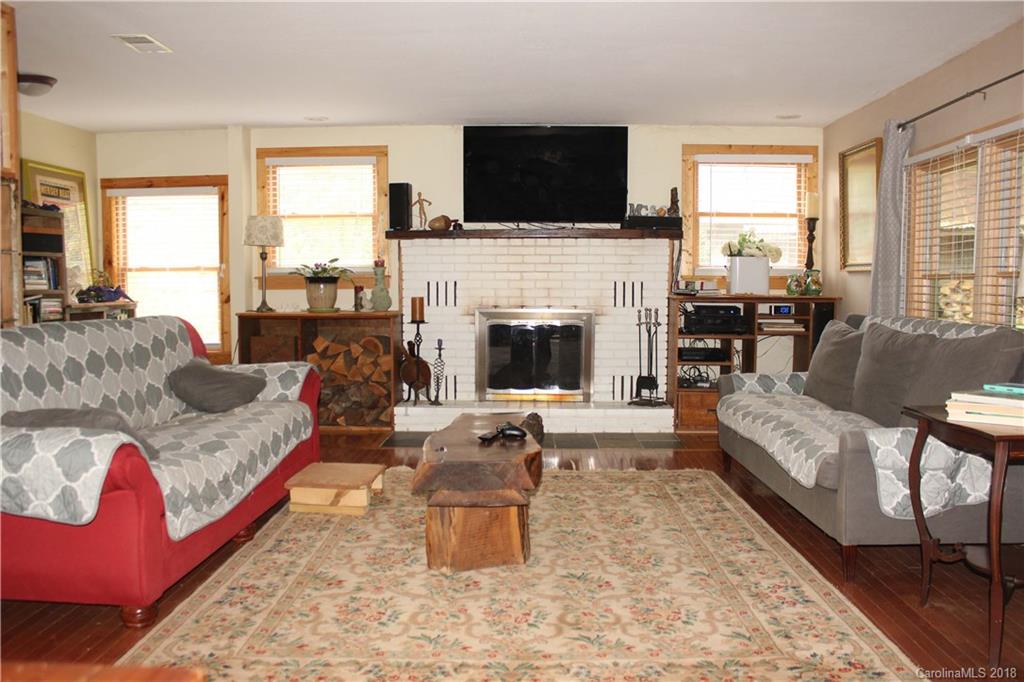 214 Huffman Road Clyde, NC 28721 - Photo 2 of 24 a living room with furniture fireplace and window