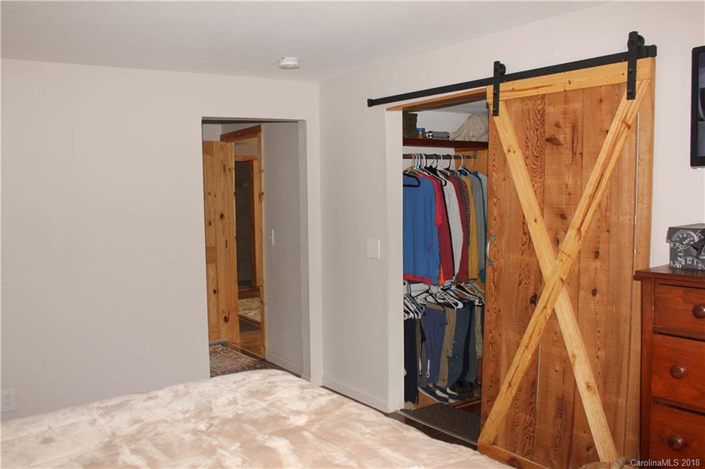 214 Huffman Road Clyde, NC 28721 - Photo 12 of 24 a view of walk in closet with clothes