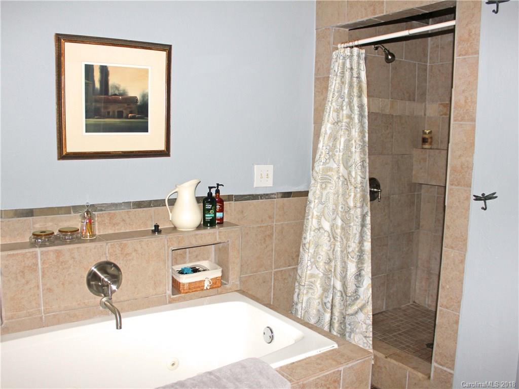 214 Huffman Road Clyde, NC 28721 - Photo 15 of 24 a bathroom with a tub sink and shower