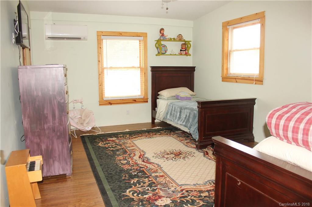 214 Huffman Road Clyde, NC 28721 - Photo 17 of 24 a living room with a couch and a dresser next to a window