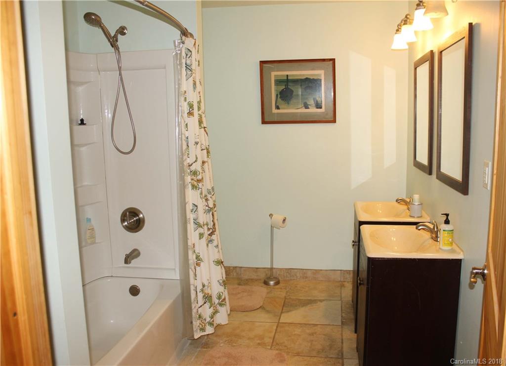 214 Huffman Road Clyde, NC 28721 - Photo 18 of 24 a bathroom with a tub sink and shower
