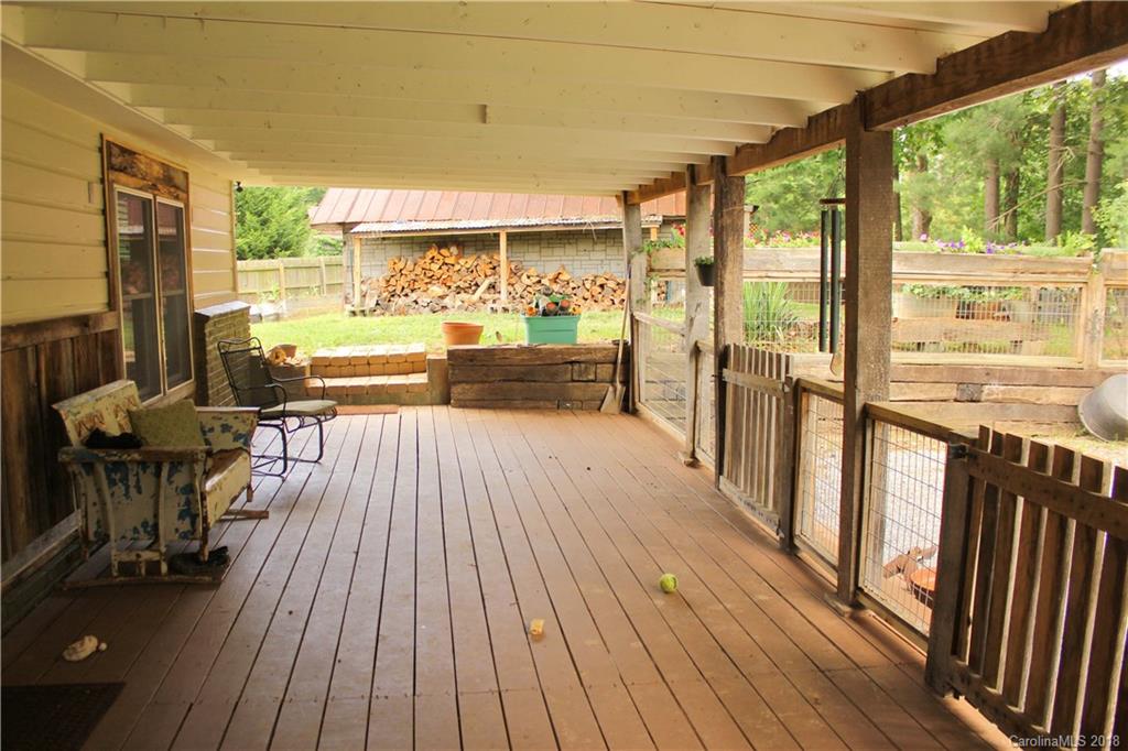 214 Huffman Road Clyde, NC 28721 - Photo 19 of 24 a view of a patio with wooden floor and outdoor seating