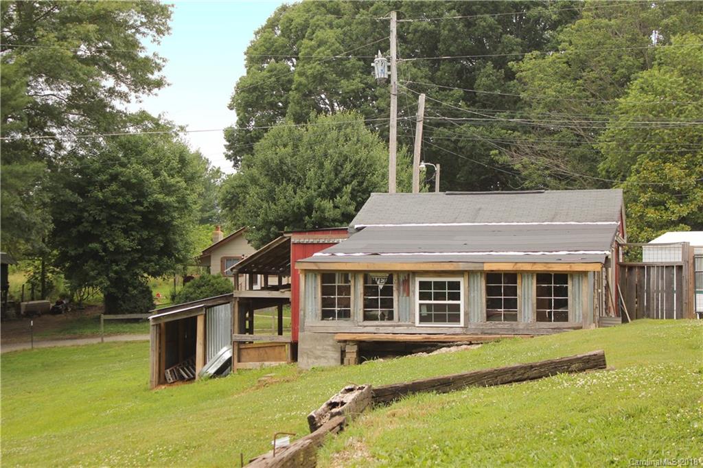 214 Huffman Road Clyde, NC 28721 - Photo 20 of 24 a front view of a house with a yard table and chairs