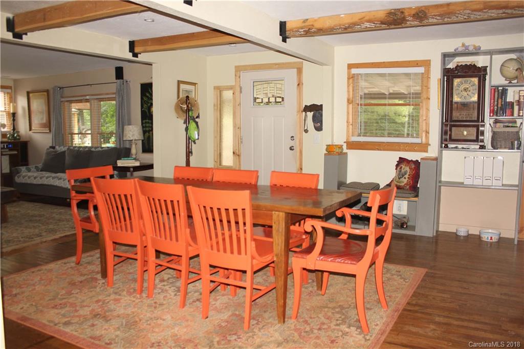 214 Huffman Road Clyde, NC 28721 - Photo 5 of 24 a view of a dining room with furniture window and wooden floor