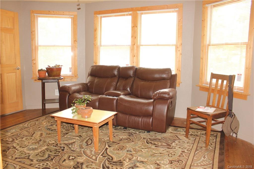 214 Huffman Road Clyde, NC 28721 - Photo 10 of 24 a living room with furniture and a window