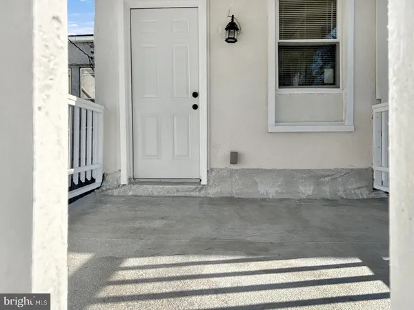 a picture of a bench in front of a wall