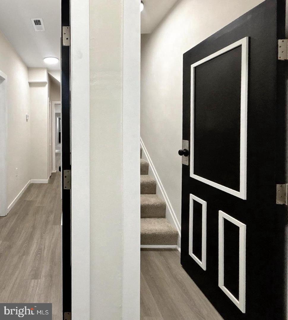 2306 Wichita Avenue Baltimore, MD 21215 - Photo 4 of 18 a view of a hallway with wooden floor and staircase