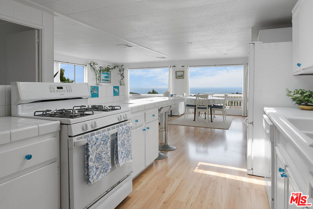 29500 Heathercliff Road, Unit 252 Malibu, CA 90265 - Photo 13 of 65 a kitchen with stainless steel appliances granite countertop a stove and a refrigerator