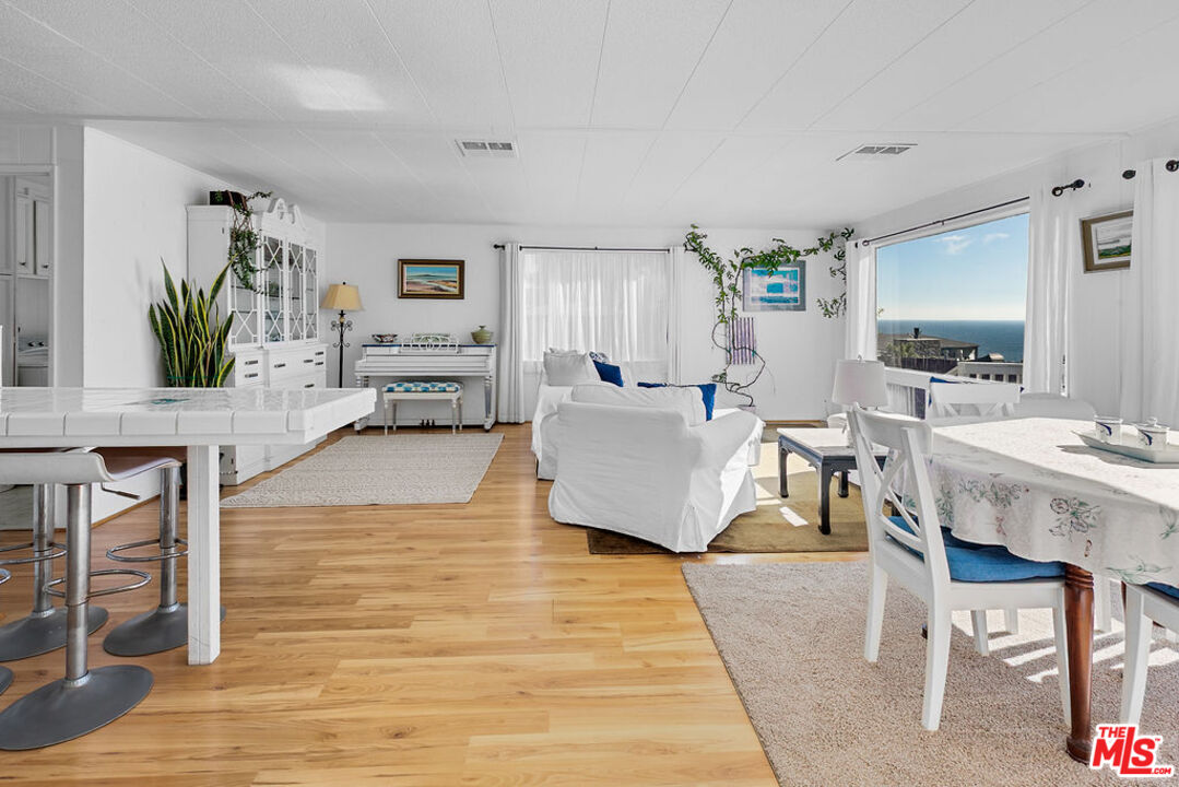 29500 Heathercliff Road, Unit 252 Malibu, CA 90265 - Photo 16 of 65 a living room with furniture and a wooden floor